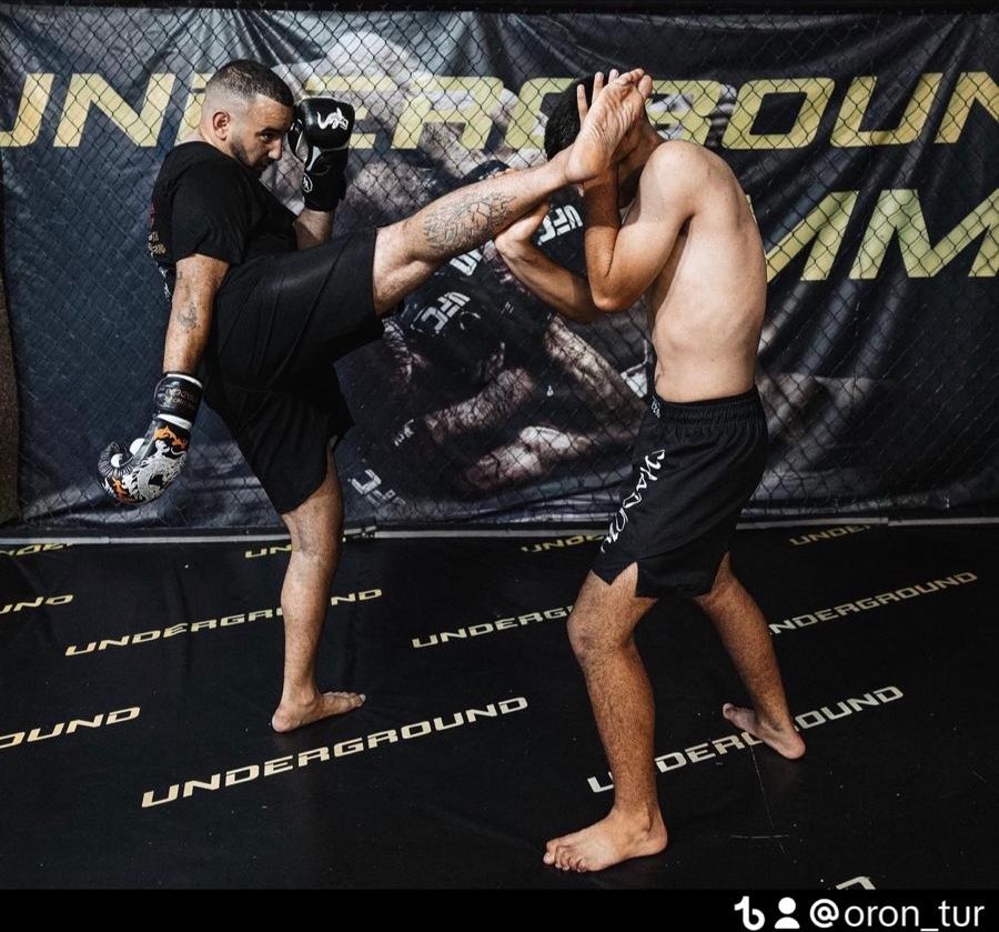 Oron throwing a high kick during Muay Thai training